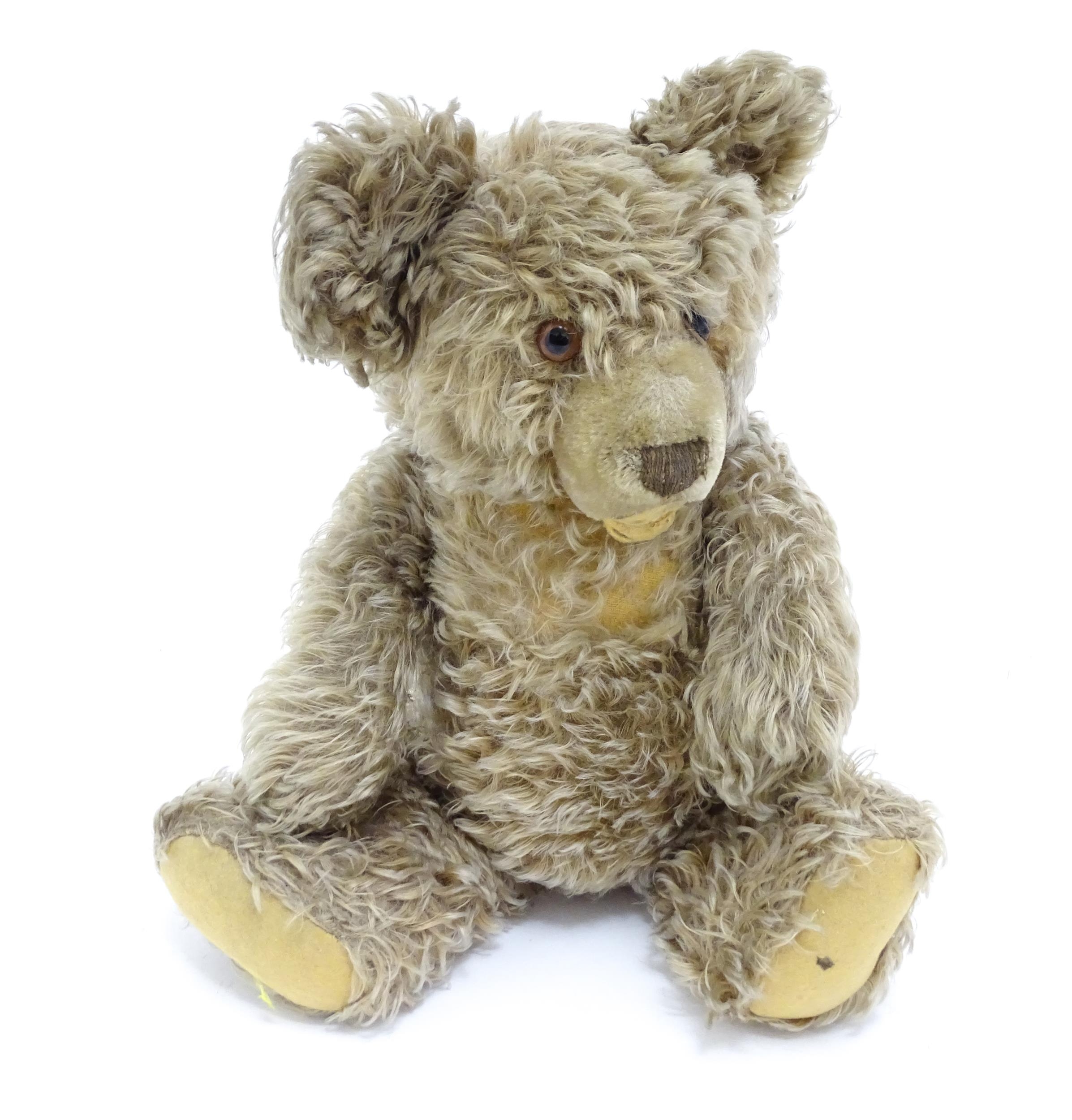 Toy: A 20thC Steiff straw filled mohair teddy bear - Zotty, with stitched nose, open mouth,