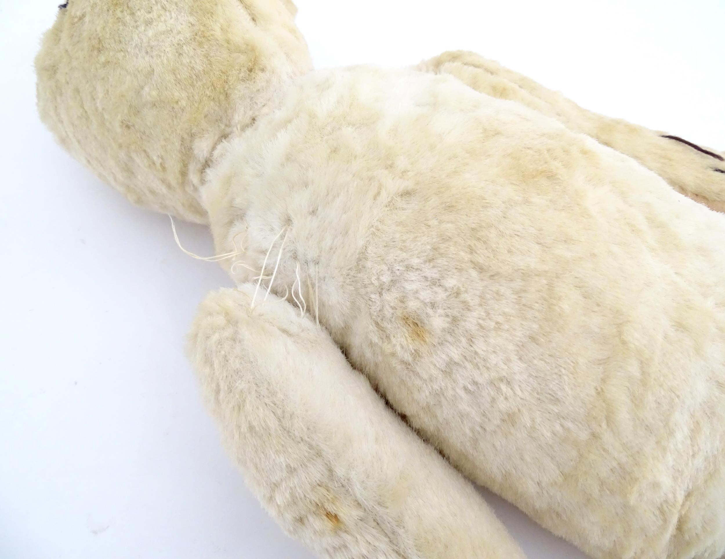 Toy: A 20thC plush teddy bear with stitched nose, mouth, eyes and paws. Approx. 19 1/2" long - Bild 7 aus 8