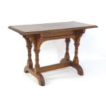 A late 19thC pine Gothic centre table, with a rectangular moulded top above four column formed