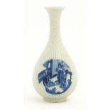 A Chinese blue and white bottle vase with fluted detail decorated with scholar figures. Character