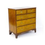 A late Georgian oak chest of drawers with a moulded top above two short over three long drawers with