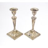 A pair of silver candlesticks with harebell swag and bow decoration. Hallmarked Sheffield 1909 maker
