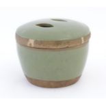 A Chinese celadon pot and cover. Character marks under. Approx. 5 1/2" high Please Note - we do