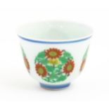 A Chinese wine cup decorated with floral roundels. Character marks under. Approx. 1 3/4" high Please