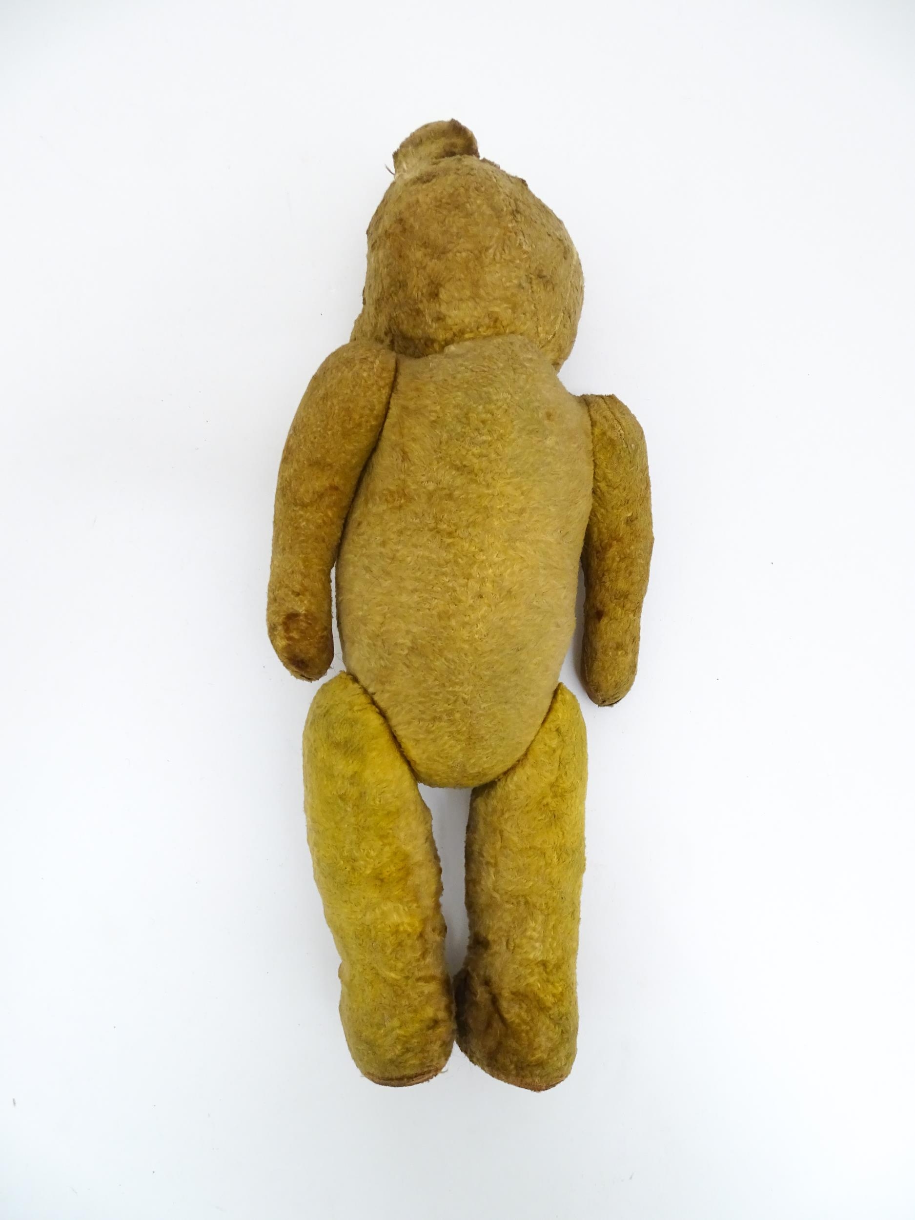 Toy: An early 20thC straw filled teddy bear with stitched nose, mouth and claws, glass eyes, pad - Bild 8 aus 8