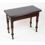 A 19thC mahogany tea table, with a hinged top above four turned tapering legs terminating in unusual