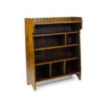 A late 19thC Arts & Crafts, Charles Lock Eastlake oak bookcase, with a shaped upstand decorated with