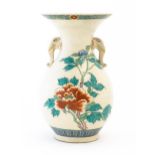 An Oriental vase with twin elephant head handles, the body with hand painted floral and foliate