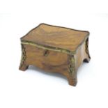 A 19thC French walnut and ormolu mounted table cabinet / casket of serpentine bombe form with