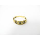 A 9ct gold ring set with three seed pearls. Ring size approx. M Please Note - we do not make