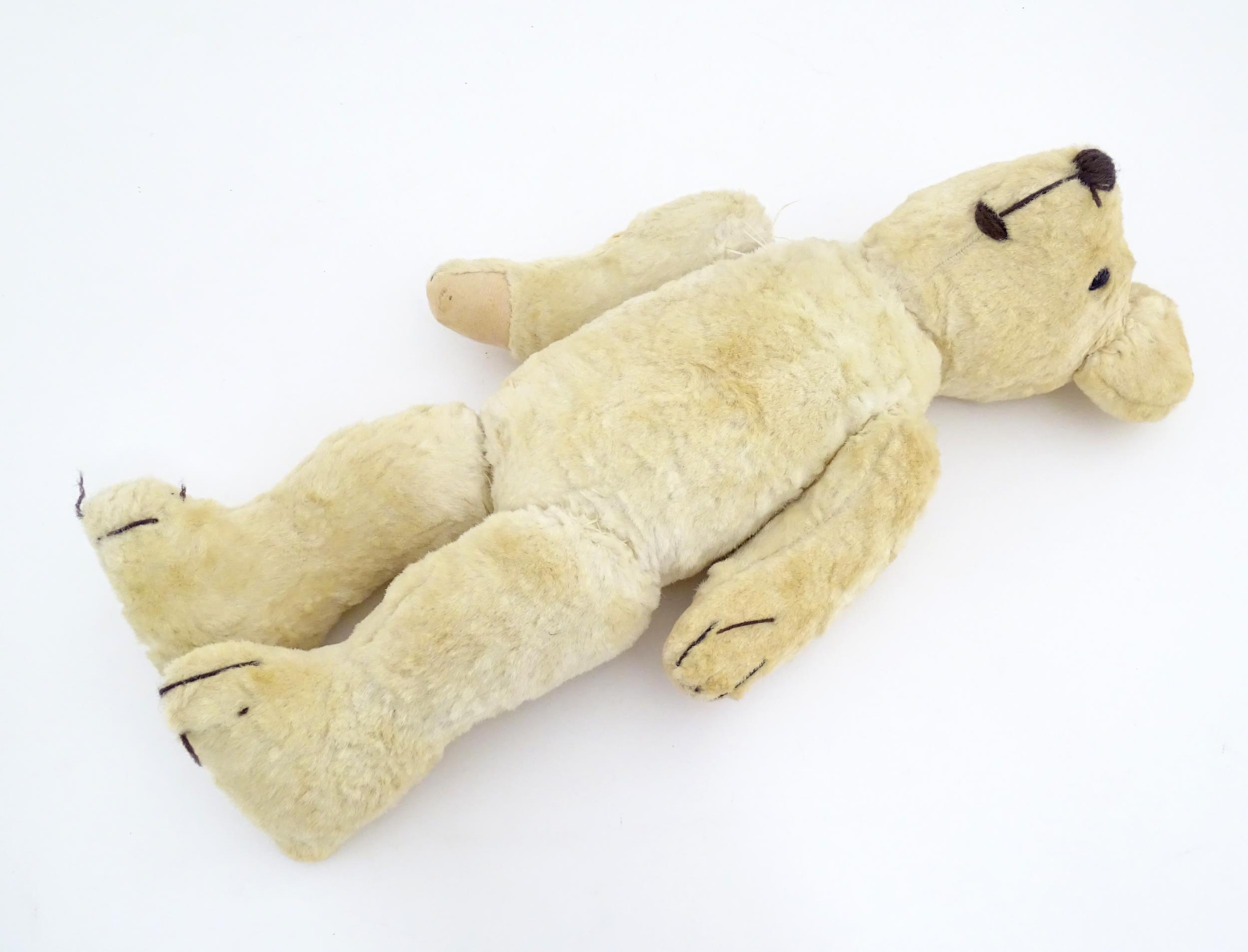 Toy: A 20thC plush teddy bear with stitched nose, mouth, eyes and paws. Approx. 19 1/2" long - Bild 3 aus 8