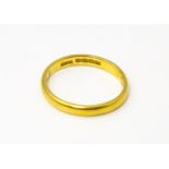 A 22ct gold ring. Ring size approx. N Please Note - we do not make reference to the condition of