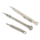 Three propelling pencils comprising a silver propelling pencil with engine turned decoration,