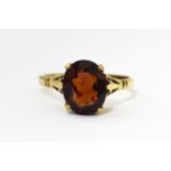 A 9ct gold ring set with central garnet. Ring size approx. M Please Note - we do not make