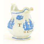 A Victorian marriage jug, the cream ground decorated in blue relief depicting figures, Classical