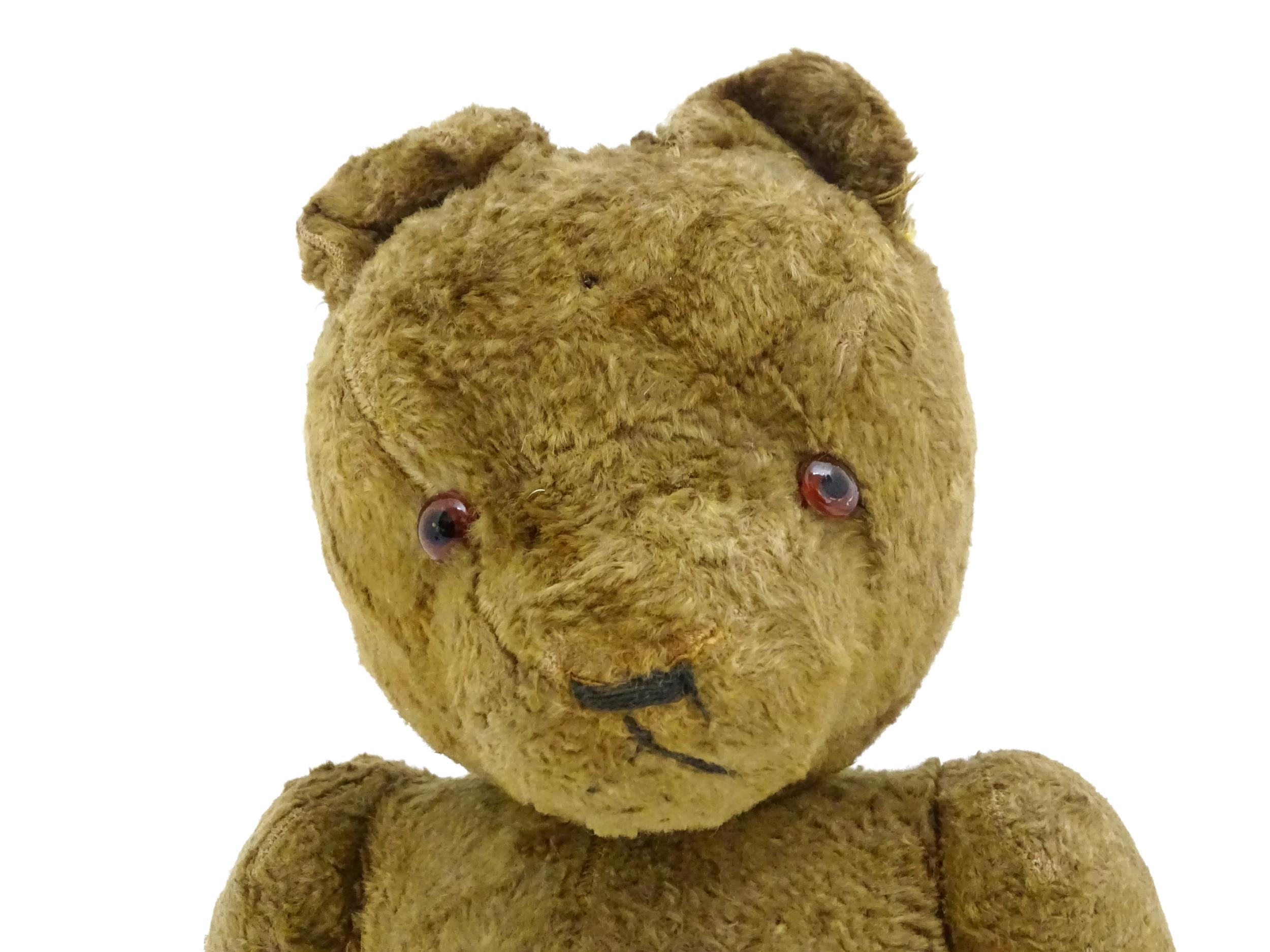 Toy: An early 20thC straw filled teddy bear with stitched nose, mouth and claws, glass eyes, pad - Bild 5 aus 8