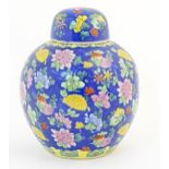A Chinese ginger jar with a blue ground decorated with flowers and foliage. Approx. 10 1/4" high