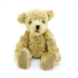 Toy: A 20thC small plush teddy bear with stitched nose and mouth, pad paws and articulated limbs,