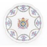 A Chinese style armorial plate with crest to centre and swag / garland detail to border. Approx.