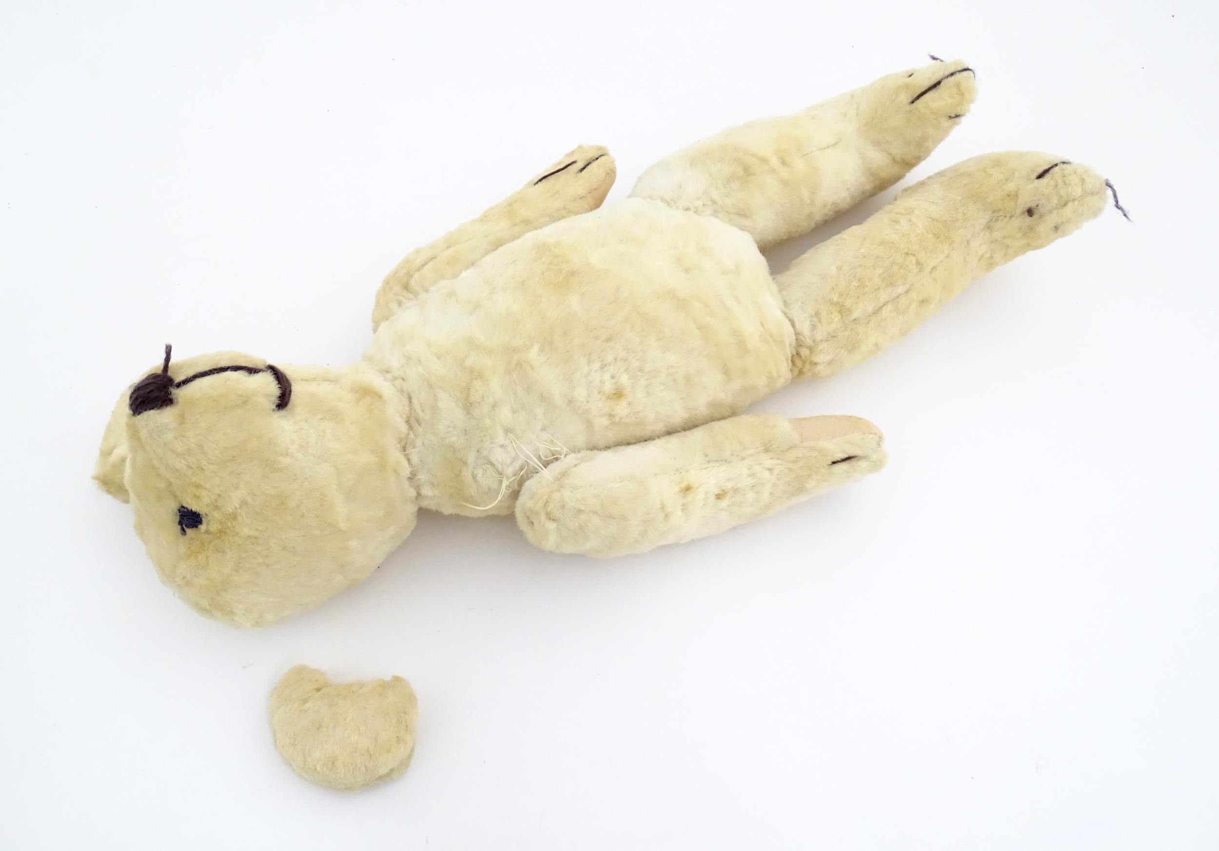 Toy: A 20thC plush teddy bear with stitched nose, mouth, eyes and paws. Approx. 19 1/2" long - Bild 5 aus 8