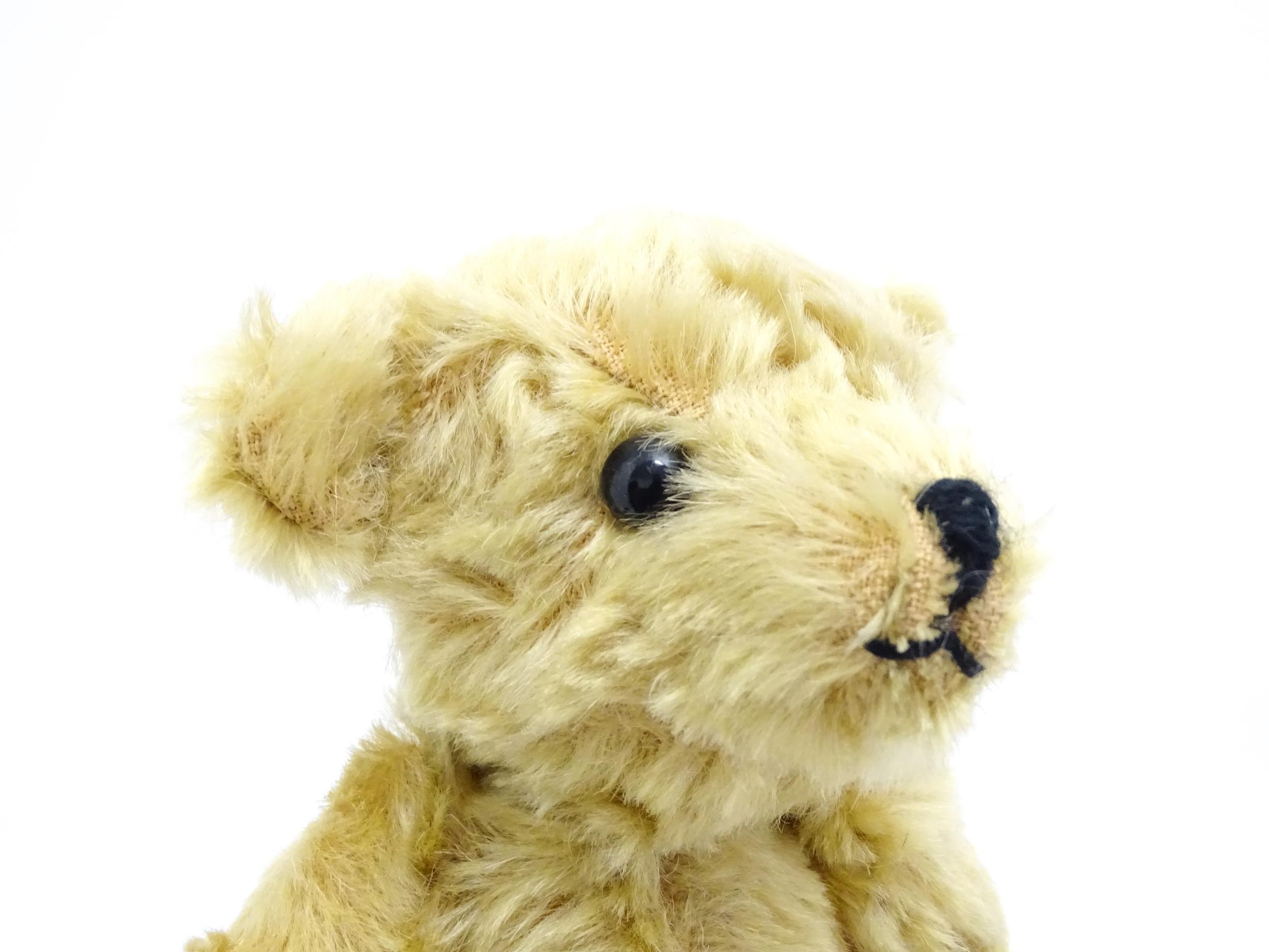 Toy: A 20thC small plush teddy bear with stitched nose and mouth, pad paws and articulated limbs, - Bild 4 aus 8