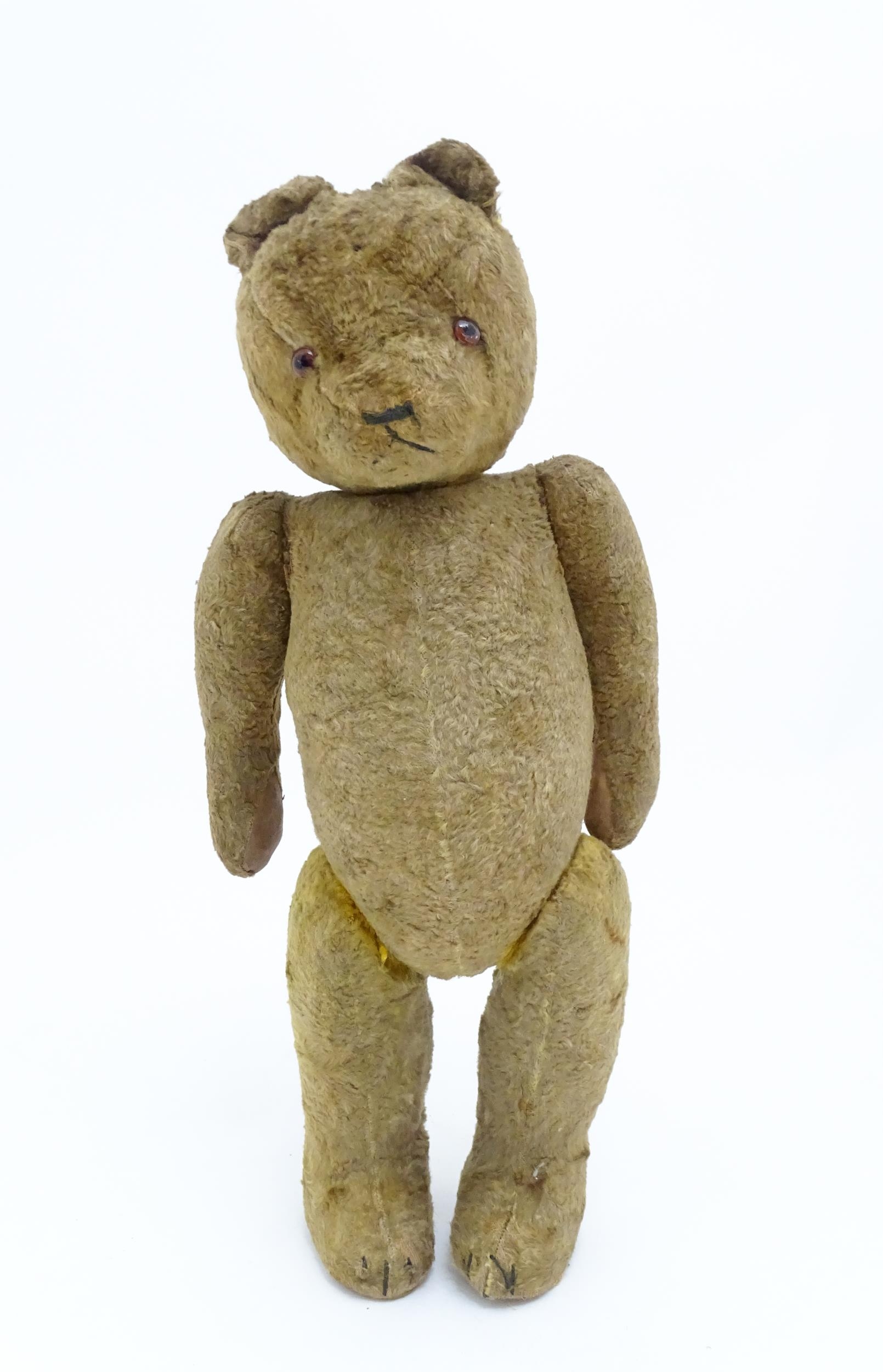 Toy: An early 20thC straw filled teddy bear with stitched nose, mouth and claws, glass eyes, pad - Bild 2 aus 8