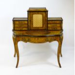 A 19thC burr walnut Bonheur du jour, with a brass gallery surmounting the two banks of three short