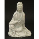 A Chinese blanc de chine figure modelled as Guanyin seated. Approx. 4 3/4" high Please Note - we