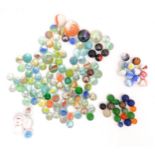 Toys: A quantity of assorted glass marbles, many with colours twists. Largest approx. 1" diameter