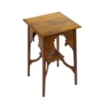 A late 19thC walnut occasional table attributed to Liberty, with a squared top above four Moorish