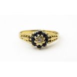A 9ct gold ring set with central diamond bordered by sapphires. Ring size approx. M Please Note - we