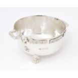 A silver Arts and Crafts style bowl modelled as The Winchester Bushel, with hammered decoration,