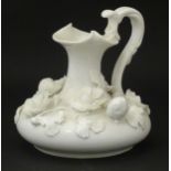 A Derby white glazed jug decorated with encrusted flowers, leaves and strawberries. Marked under.