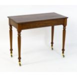An early 20thC mahogany side table with a moulded rectangular top above four turned tapering legs