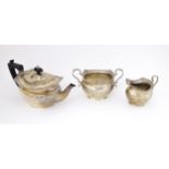 A Victorian silver three piece tea set comprising teapot, milk jug and sugar basin. Hallmarked