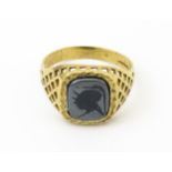 A 9ct gold gentleman's intaglio ring set. Ring size approx. T 1/2 Please Note - we do not make