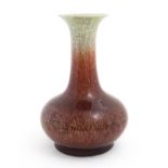A Chinese sang de boeuf vase with a flared rim and crackle glaze. Indistinctly marked under. Approx.