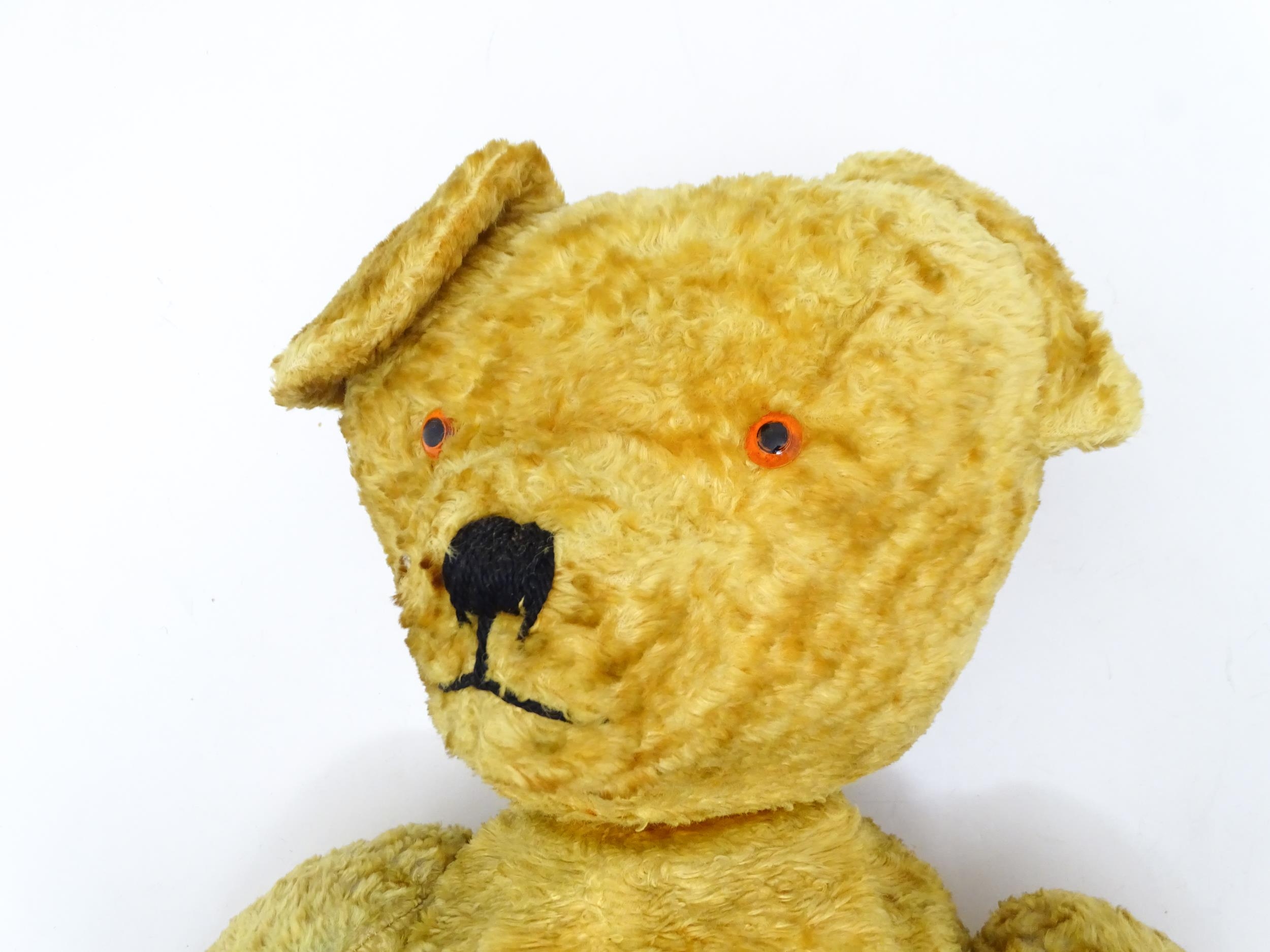 Toy: A large 20thC straw filled teddy bear with a stitched nose and mouth, and articulated limbs. - Bild 4 aus 8