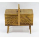 A wooden cantilever sewing box. Approx. 16" high x 16 1/2" wide x 9 1/4" deep Please Note - we do