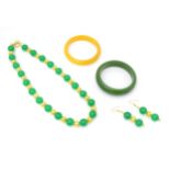 Assorted jade jewellery to include bead necklace and earrings and two bangles. Please Note - we do
