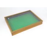 A display case / table top vitrine. Approx. 3" high x 21" wide x 15" deep Please Note - we do not