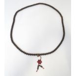 An Oriental wooden bead necklace. Approx. 22" long Please Note - we do not make reference to the