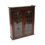 An early 20thC oak cabinet with two leaded glass panelled doors. Approx 34" wide x 40 1/2" high