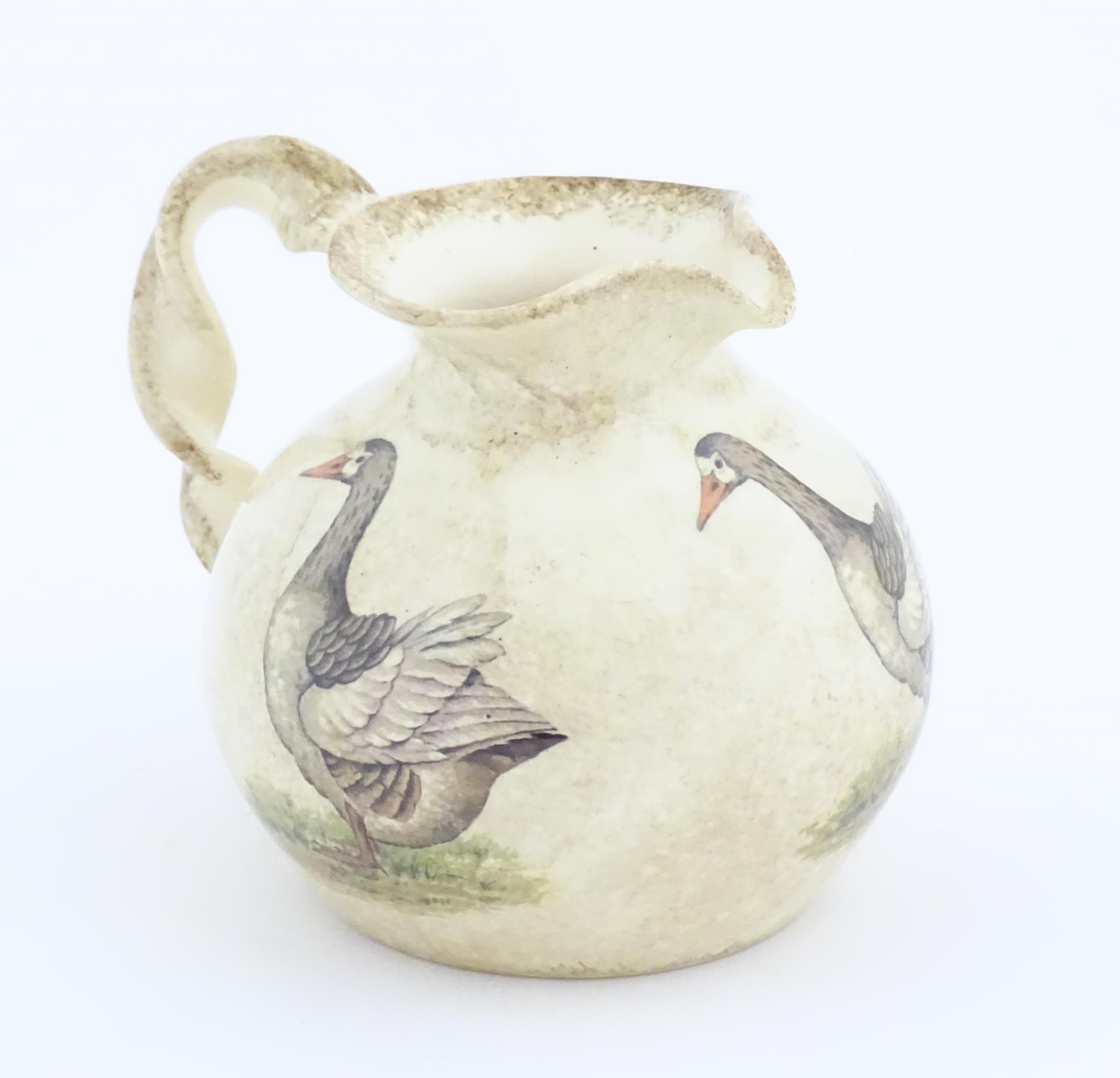 A Yorkshire Moorlands pottery jug with twist handle decorated with geese. Marked under. Approx. 4 - Image 3 of 8