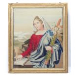 A 20th century religious tapestry / needlework depicting a female saint holding a cross with