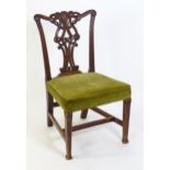A late Georgian mahogany Chippendale style side chair, having a carved back splat and raised on
