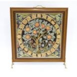 A late 20thC fire screen with William Morris style Apple tree design panel to centre. Standing 26"