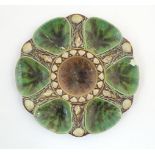 A Minton majolica oyster plate with relief shell decoration. Impressed marks under. Approx. 9 1/4"