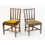 A pair of late 19thC / early 20thC side chairs with reeded back rails and drop in seats above
