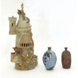 Three items of studio pottery to include a model of a tower with turrets and dragon detail by a